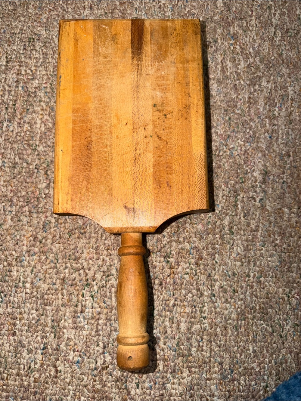 vintage wooden paddle, likely a small bread peel or a primitive kitchen cutting